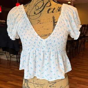 Size medium white cropped top with deep v neck, blue butterflies and puff sleeve